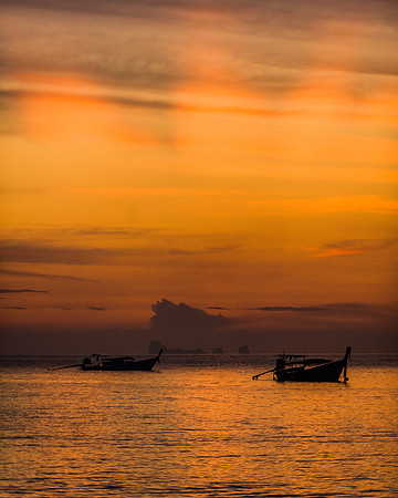 Longtail boats at sunset